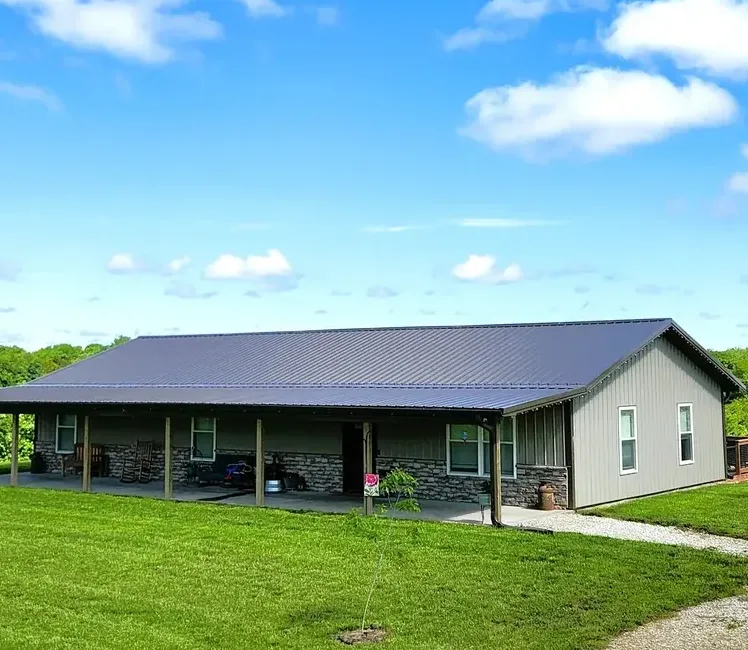 Gray custom home with a full-length covered porch and stone-clad columns