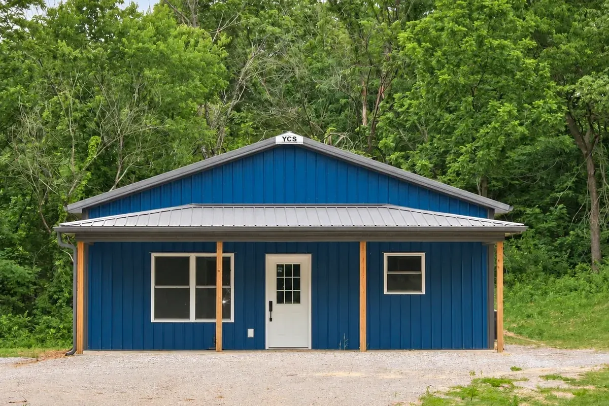 Blue hobby shop with a covered porch and no overhead door